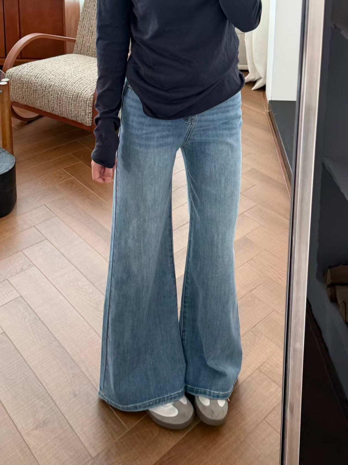 Front detail of light blue flare jeans