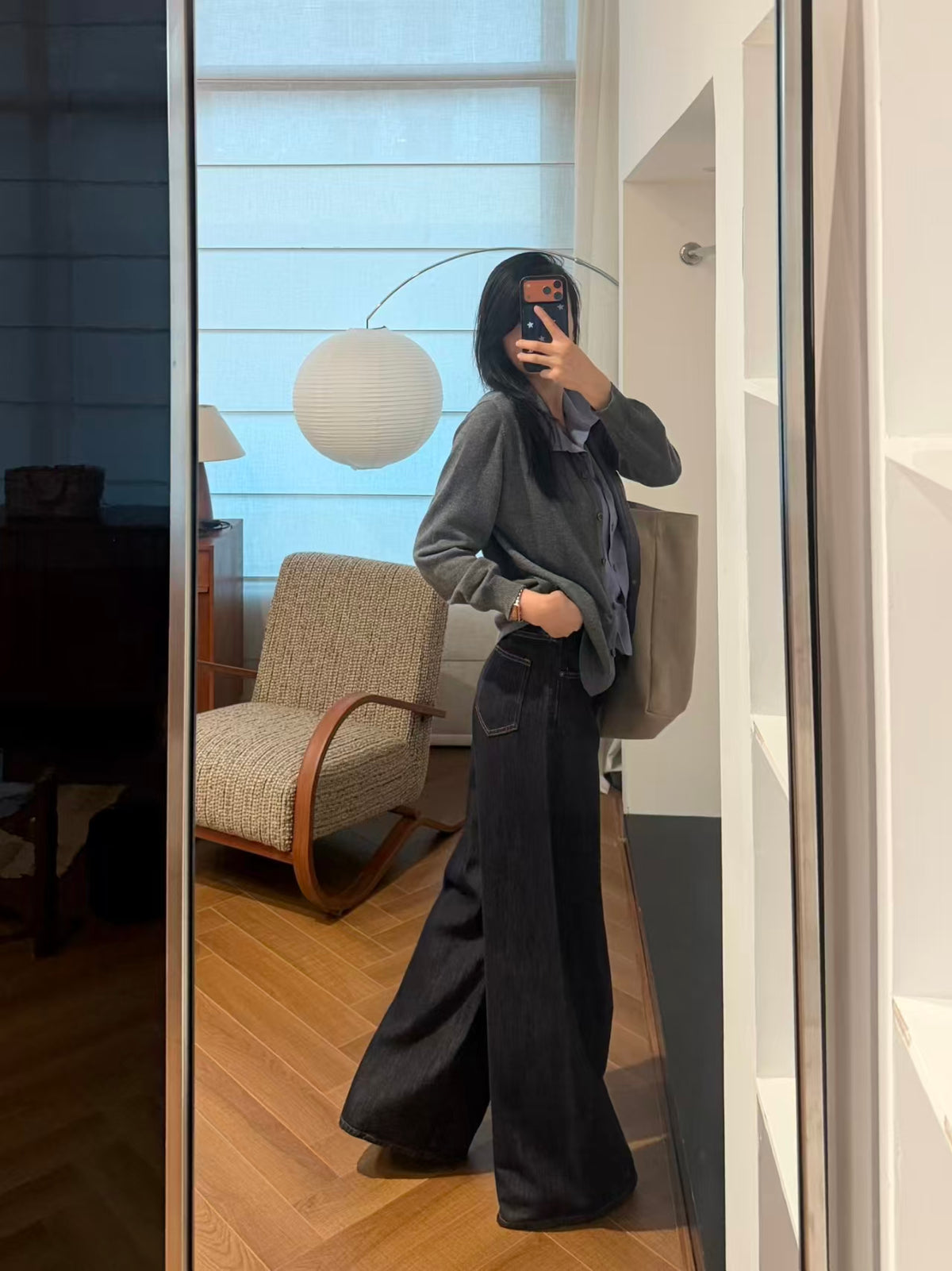 Side mirror shot showing relaxed drape and wide-leg trouser pairing