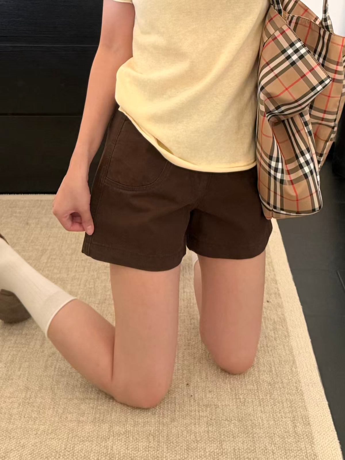 Brown shorts lying flat detail showing pocket lining