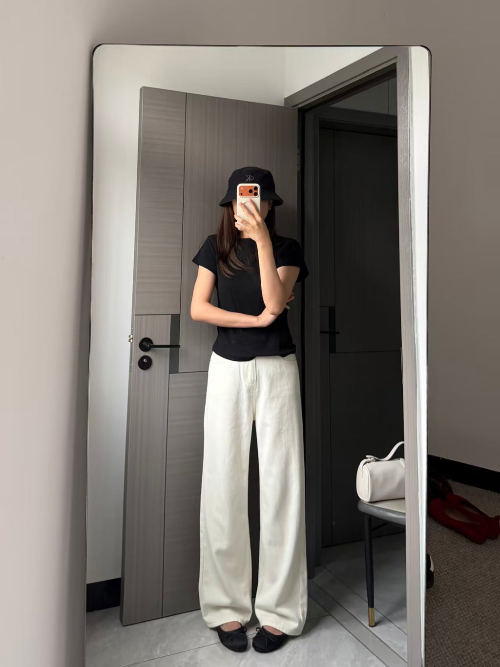 Cream wide-leg trousers close-up showing fabric drape and leg opening