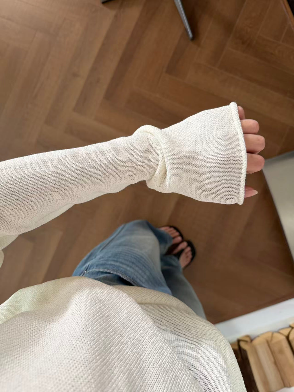 Full-length mirror shot showing relaxed drape with jeans