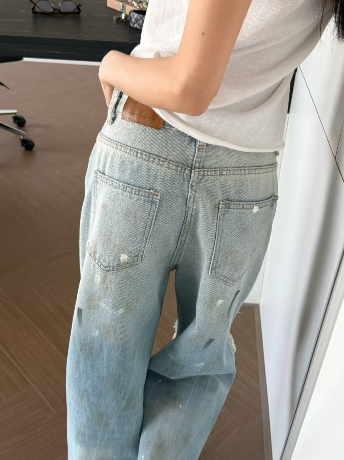 Distressed Paint Splatter Wide Leg Jeans - seated front view full leg